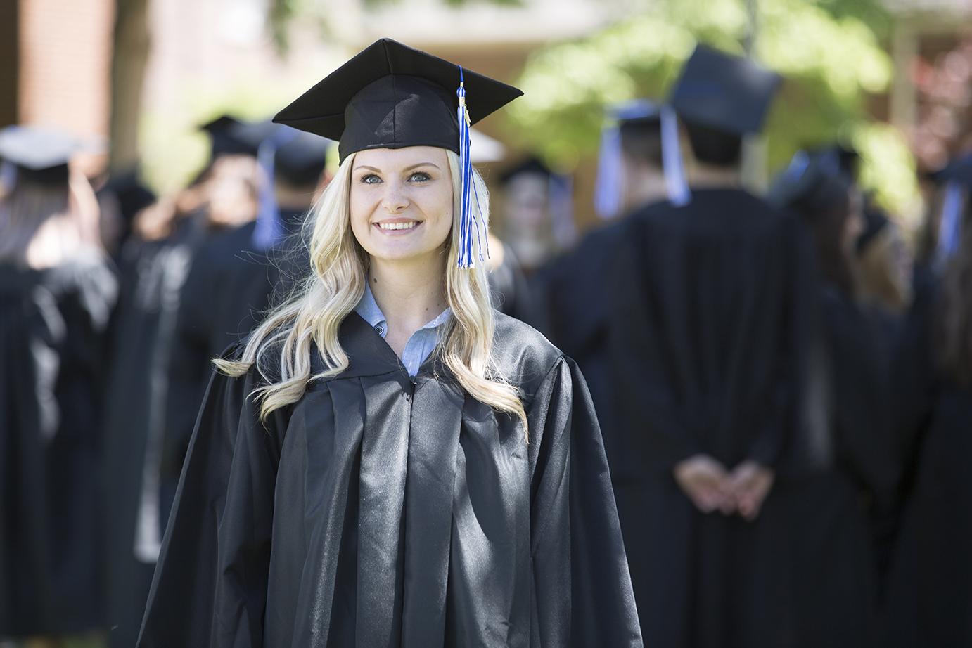 Graduate in cap and gown at graduation